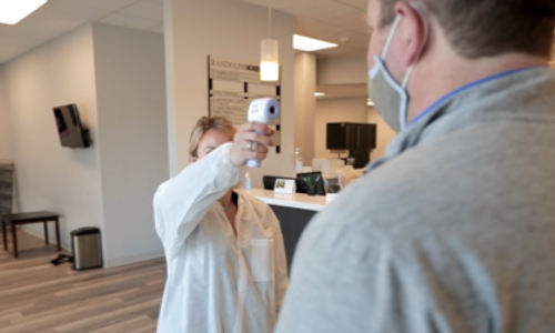 Staff checking temperature at Stony Brook Dental