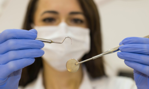 Dentist holding dental instruments